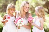 Bride With Bridesmaids Outdoors At Wedding