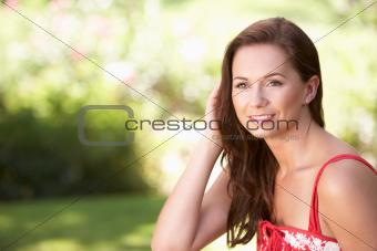 Portrait Of Young Woman Relaxing In Park