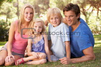 Young parents with children posing in a park