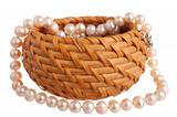 Pink pearl nacklace in a basket