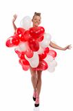 blonde girl with many balloons on her body with open arms