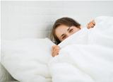Woman hiding behind blanket