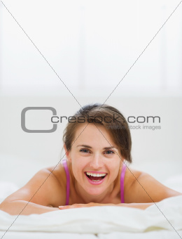 Portrait of happy girl laying on bed