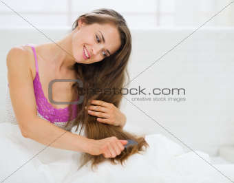 Happy girl brushing hair