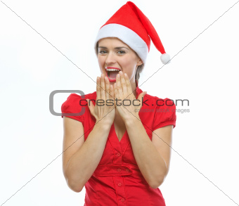 Portrait of surprised young woman in Santa hat