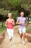 Senior couple running in park