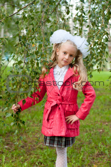 Schoolgirl dressed in a birch forest