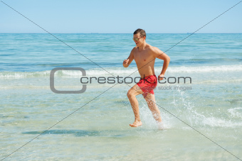 man running along the coast