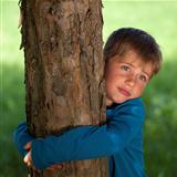 Little boy embracing a tree