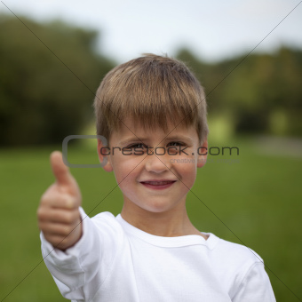Young boy showing thumbs up