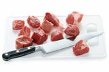 dicing raw lamb with a kitchen knife