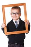 Smiling clever boy in wooden frame 