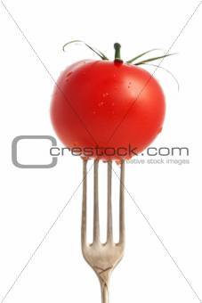 tomato on a fork isolated on white 
