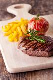grilled steak with fries and tomato 