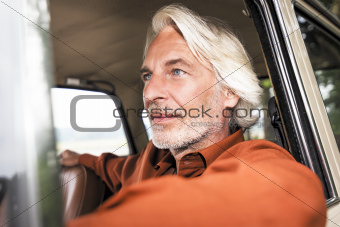 man in his car