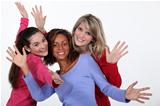 Three female friends waving