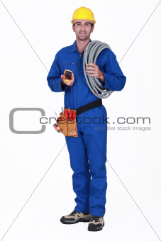 Tradesman holding his tools and corrugated tubing