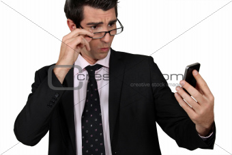 businessman looking at his cell