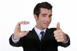 Thumbs up form n executive with blank business card