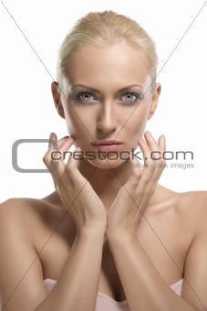 beauty portrait of blonde girl with fingers near the face