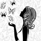Silhouette of young woman with flying butterflies