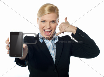 Saleswoman displaying new iphone to camera