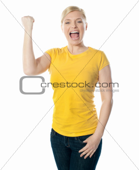Fashionable teenager poisng with raised arms
