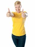 Happy young woman showing double thumbs-up