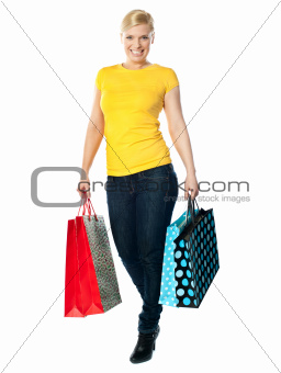Attractive girl carrying colourful shopping bags