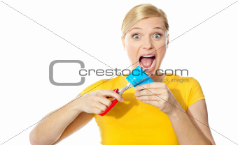 Excited female cutting her credit card