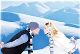 Happy couple playing outdoor at winter mountains