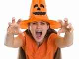 Woman in Halloween hat making scaring pose