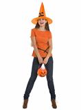 Happy woman holding Halloween bucket with sweets