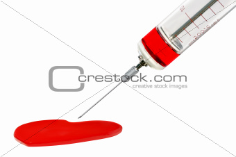 Old glass syringe and heart against white background