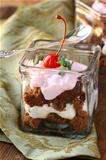 chocolate biscuits with cream , trifle in glasses