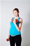 Pregnant woman exercising with dumbbells