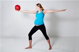 Pregnant woman exercising with exercise ball