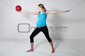 Pregnant woman exercising with exercise ball