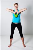 Pregnant woman exercising with kettlebell