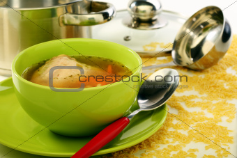 Soup in bowl and stainless steel pan.