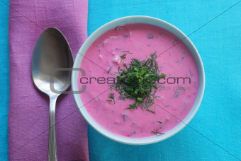 Chlodnik - cold beetroot soup in a bowl on a tablecloth