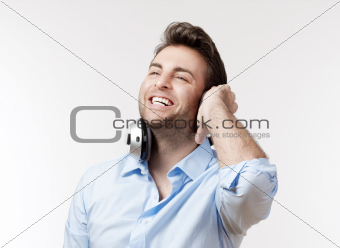 excited man in blue shirt with earphones listening to music 