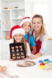 Kids with their mother making christmas cookies