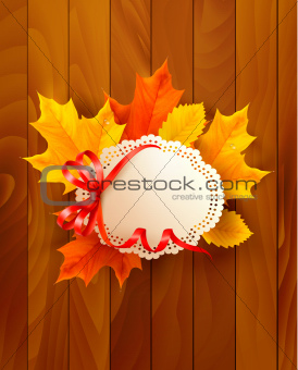 Card with leaves with a bow on wooden background. Vector.