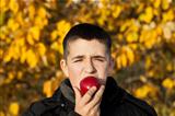 Boy starts to eat an apple