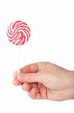 Hand holding spiral lollipop 