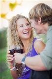 An Attractive Couple Enjoying A Glass Of Wine in the Park Together.