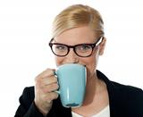 Attractive corporate female drinking coffee