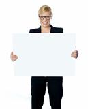Attractive businesswoman holding blank advertising board
