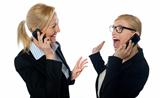 Happy businesswomen communicating on cellphone